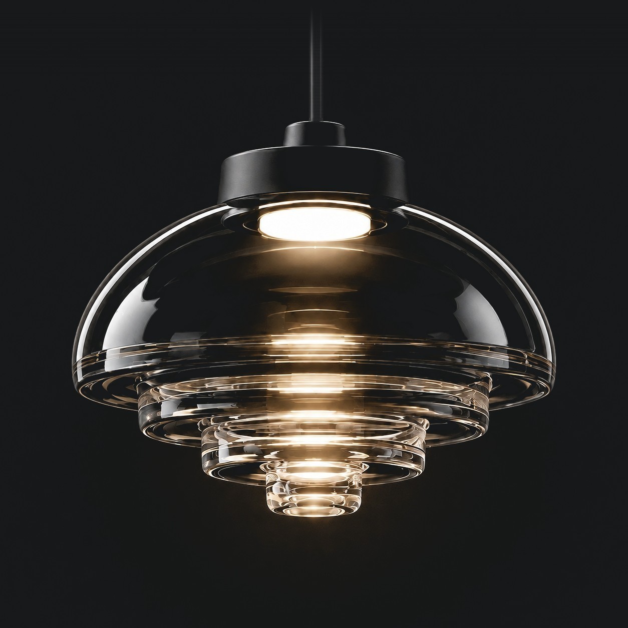 Viro Fresnel pendant with clear stepped glass illuminated against a dark background